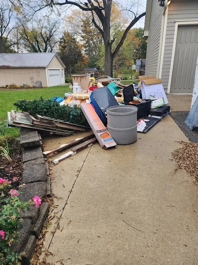 Dumpster being loaded with debris for Roofing Dumpster Rental in Crestview Hills